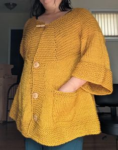 This is a flared cardigan made with soft acrylic yarn in a golden yellow color. The cardigan has a buttoned front, crew collars and three quarter sleeves. Shoulder width measures at 18 inches, 14 inch sleeves, and the garment measures 26 inches from the neck down in the back. One patch pocket on the left side. Please feel free to contact me if you question in sizing or anything else! Flared Cardigan, Golden Yellow Color, Colorful Boho, Golden Yellow, Three Quarter Sleeves, Yellow Color, Acrylic Yarn, Three Quarter, Half Sleeves