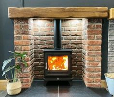 a brick fireplace with a wood burning stove