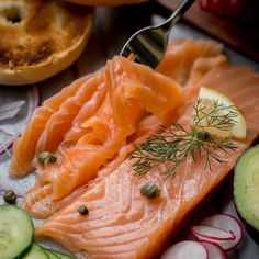 a plate topped with salmon and cucumbers