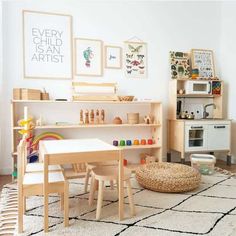 a child's playroom with wooden furniture and art work on the wall above it