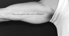 a man's arm with a quote on it