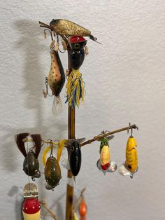 there is a tree made out of different types of fishing lures hanging from hooks