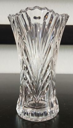 a glass vase sitting on top of a table