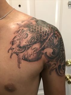 a man with a dragon tattoo on his chest