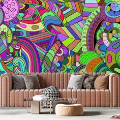 an artistic wall mural in a living room with couches and pillows on the floor