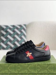 Step into refined style with these Ace-inspired sneakers, paying homage to Gucci's signature aesthetic. The sleek black leather upper is adorned with a playful golden bee embroidery, adding a touch of whimsy and luxury. The iconic web stripe detail in green and red elevates the look, while the comfortable fit ensures all-day wearability. Perfect for adding a touch of sophistication to your everyday style. Luxury Black Sneakers With Embroidered Logo, Signature Aesthetic, Edgy Accessories, Bee Embroidery, Gucci Sneakers, Loafer Sneakers, Refined Style, Bottega Veneta Shoulder Bag, Green And Red