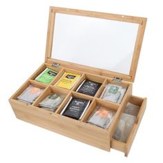 an open wooden box filled with different types of teas and coffee bags on top of each other