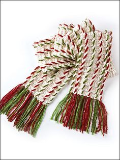 two red, white and green knitted scarves with fringes on each side