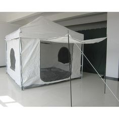 a tent that is in the middle of a room with white walls and flooring