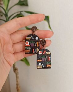 a pair of earrings that have been made out of books and other things on them