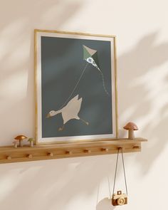 a bird flying with a kite on it's string next to a wooden shelf