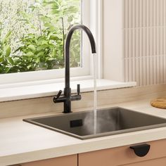 a kitchen sink with a faucet running water from it's spout