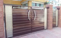 a large brown gate in front of a house