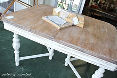 a wooden table with some books on it and a book sitting on top of it