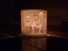 a lit candle with two children on it