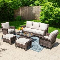 an outdoor patio furniture set with beige cushions and white cushions, sitting on a blue rug