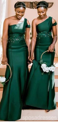 two women in green dresses standing next to each other