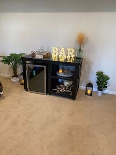 a dog is sitting on the floor in front of a bar with lights and decorations