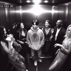 a group of people standing around in a elevator