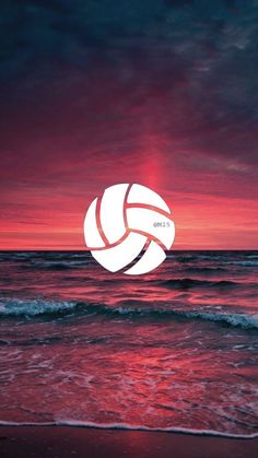 a white volleyball ball is in the air above the water at sunset or sunrise on an ocean beach