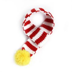 a red and white striped scarf with a yellow pom - pom