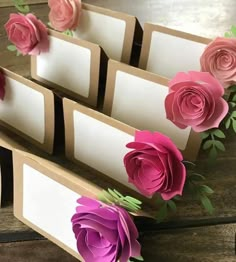 there are many paper flowers on top of each other in this set of place cards