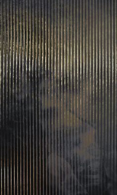 an image of a cat that is looking out from behind the blinds in front of it