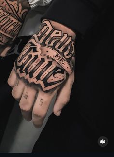 a person with tattoos on their hands and arms