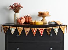 a black dresser topped with lots of different types of food and decor on top of it