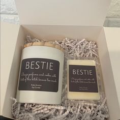 two candles in a box with shredded paper around them and the words bestie written on it