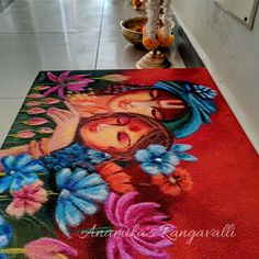 a painting on the floor with flowers and a woman's face painted on it