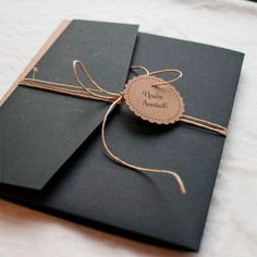 two black cards tied with twine on top of each other