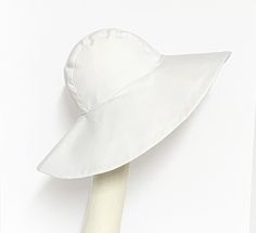 Wide Brim sun hat made with white cotton twill, lined in rayon print, the hat has a 2 section crown 3 1/2 " in length and a one piece 5" brim, a cotton band inside. One size fits most up to 23" Machine wash cold / hand dry Made in USA Press if needed / packable Lightweight White Hats For Spring, White Lightweight Bucket Hat, Lightweight White Sun Hat With Curved Brim, Lightweight White Sun Hat For Spring, White Sun Hats For Travel, Classic Summer Cotton Bucket Hat, Lightweight White Brimmed Sun Hat, Classic Cotton Sun Hat With Curved Brim, Classic Cotton Sun Hat For Spring