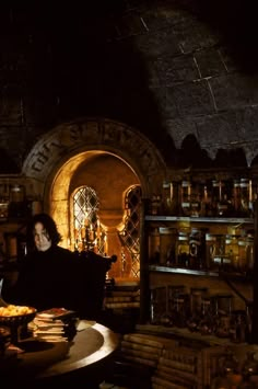 a man sitting at a table in a dark room