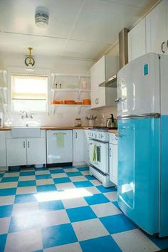 a kitchen with blue and white checkered flooring