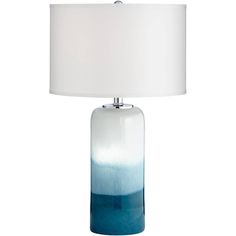 a blue and white table lamp with a white shade on the top, sitting against a white background