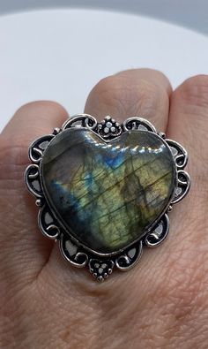 Huge heart carved blue green Labradorite rainbow moonstone Lovely vintage silver setting is low content silver Size 7 Can be re sized for you for $20 jeweler's fee About an inch long Ring is long covers from knuckle to knuckle. All rings are shipped in a nice gift box. Check out our over a THOUSAND great reviews Engraving is $4 per letter and is not always perfect depending on the piece. It can take a few days if the jeweler is busy. This is payable to Paypal Judithsltd@gmail.com Unique Handmade Heart Cut Jewelry, Vintage Labradorite Rings For Gift, Nickel-free Labradorite Jewelry For Anniversary, Anniversary Nickel-free Labradorite Jewelry, Handmade Bohemian Heart-shaped Rings, Vintage Labradorite Gemstone Jewelry, Vintage Labradorite Ring, Handmade Bohemian Heart Ring Gift, Bohemian Handmade Heart Ring Gift