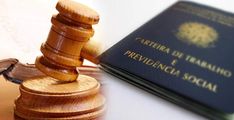 a wooden judge's gavel sitting on top of a table next to a book