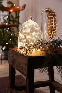 a wooden table topped with a glass dome covered in lights