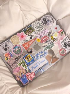 an open laptop computer covered in stickers