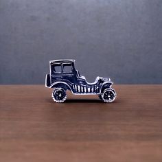 a toy car sitting on top of a wooden table