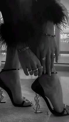 two women's feet with rings on them and one is wearing high heel sandals