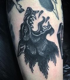 a black and white photo of a tattoo on someone's arm with an eagle