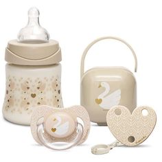 a baby's bottle, pacifier and bib are shown in this image