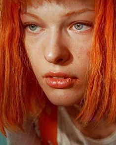 a close up of a person with red hair