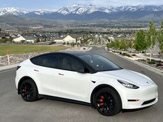 a white car parked on the side of a road