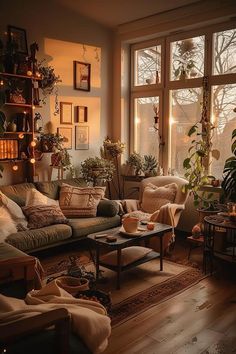 a living room filled with lots of furniture next to a large window covered in potted plants