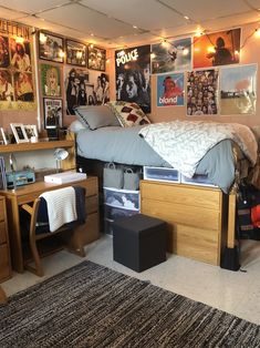 a bed room with a neatly made bed and lots of pictures on the wall