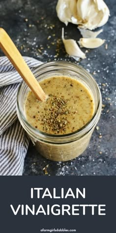 an image of italian vinaigrette sauce in a glass jar with a wooden spoon