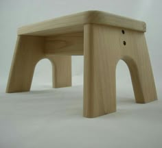 a small wooden bench made to look like an elephant